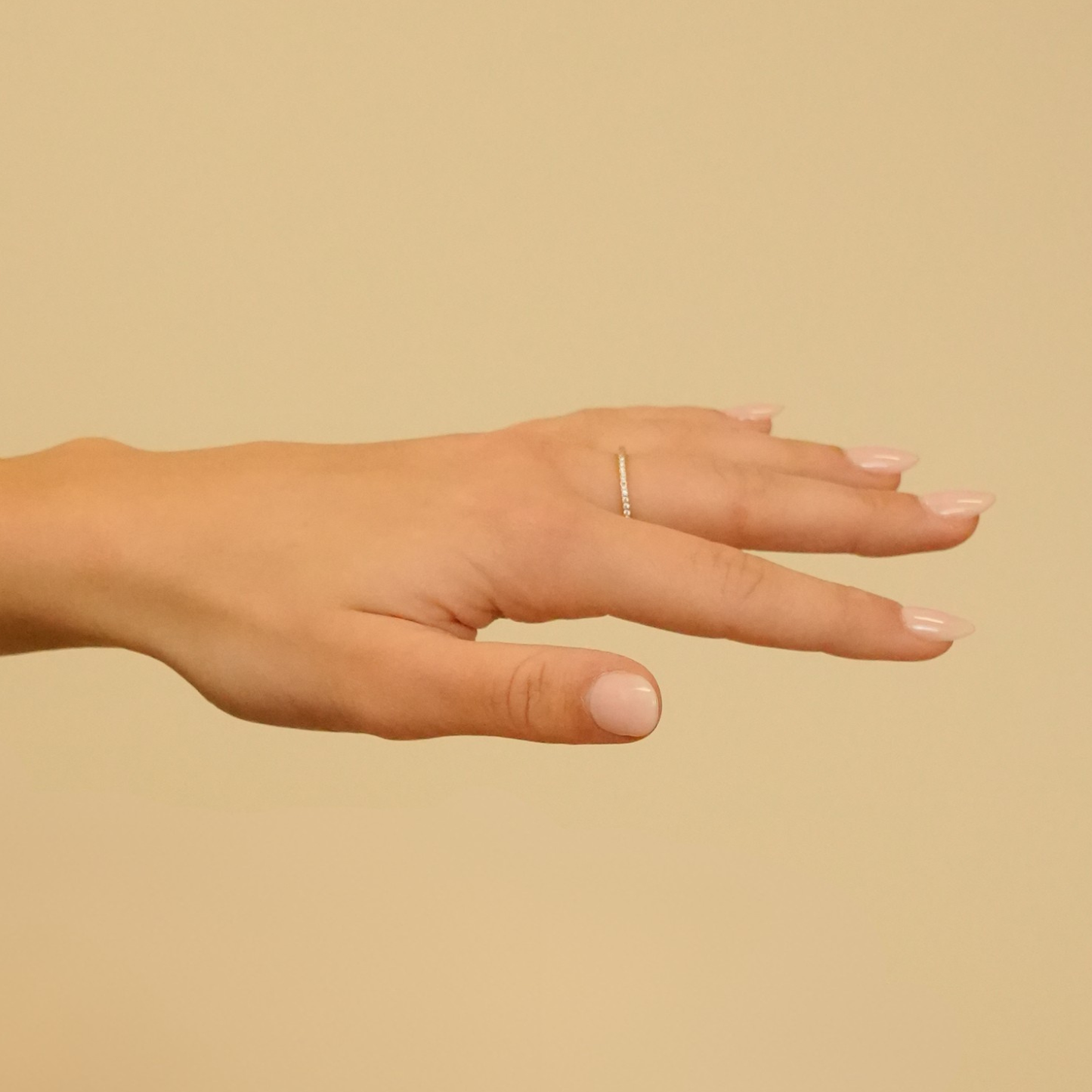 Gold ring with zirconia embellishments, from Timeless Spark, shown on a hand against a neutral background.

