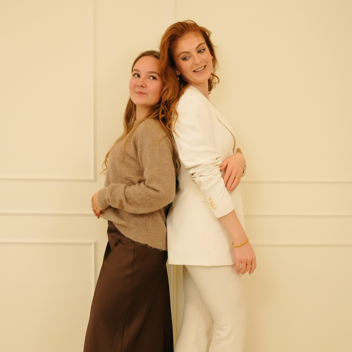 Gold bracelet, with no brand attribution, worn with a white blazer and pants.