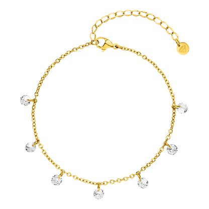 Gold charm bracelet by Ariane, adorned with sparkling crystals, set against a dark green background.