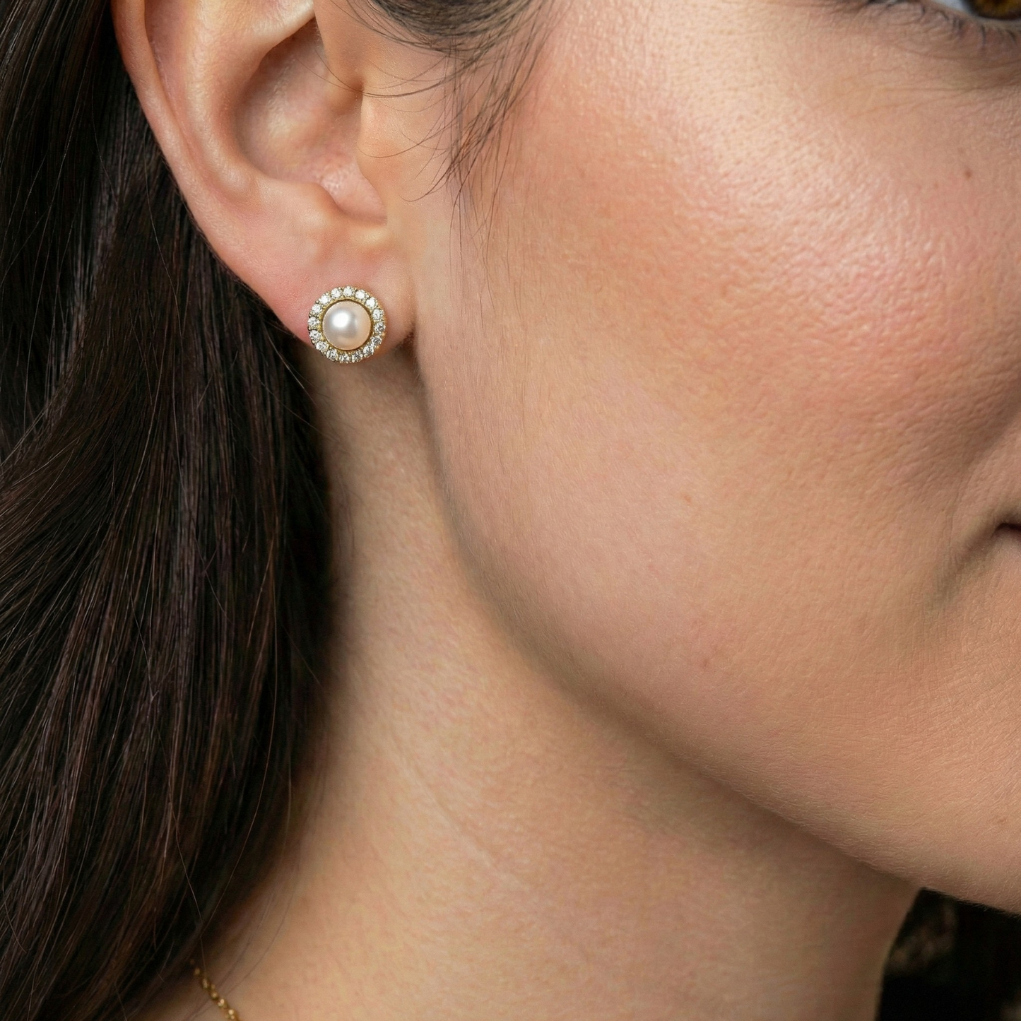 Pearl stud earrings by Petit Amour featuring a diamond halo setting