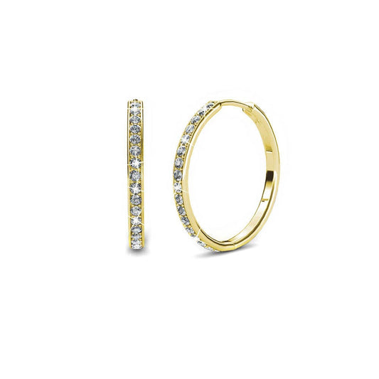 Gold hoop earrings with embedded stones on a white background