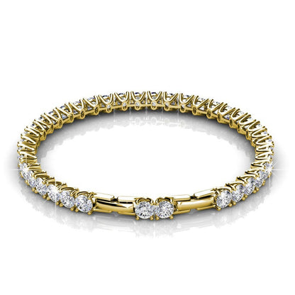 Gold bracelet with clear gemstones on a white background
